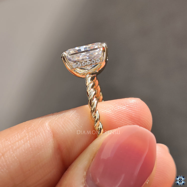 Moissanite for an engagement ring crafted with yellow gold twisted shank.
