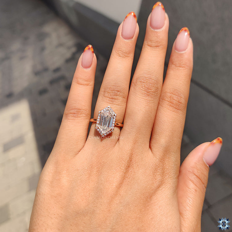 Handmade jewellery piece featuring open gallery and round cut halo.
