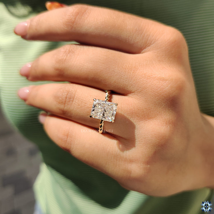 Diamondrensu UK engagement ring with twisted band and radiant centre stone.
