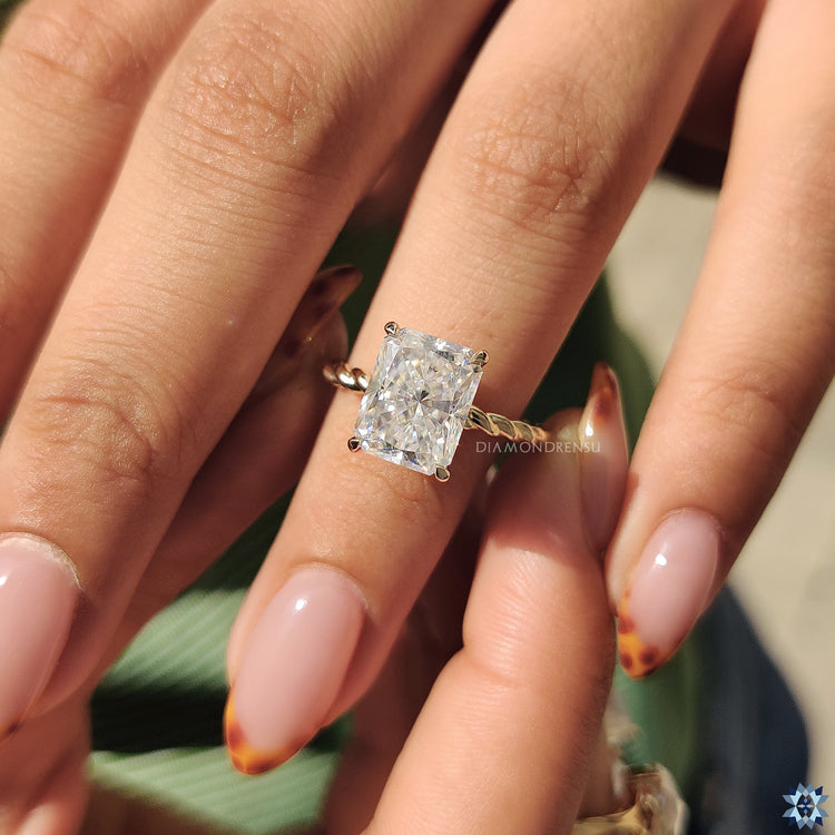 Custom handmade jewellery ring with radiant moissanite and twisted design.
