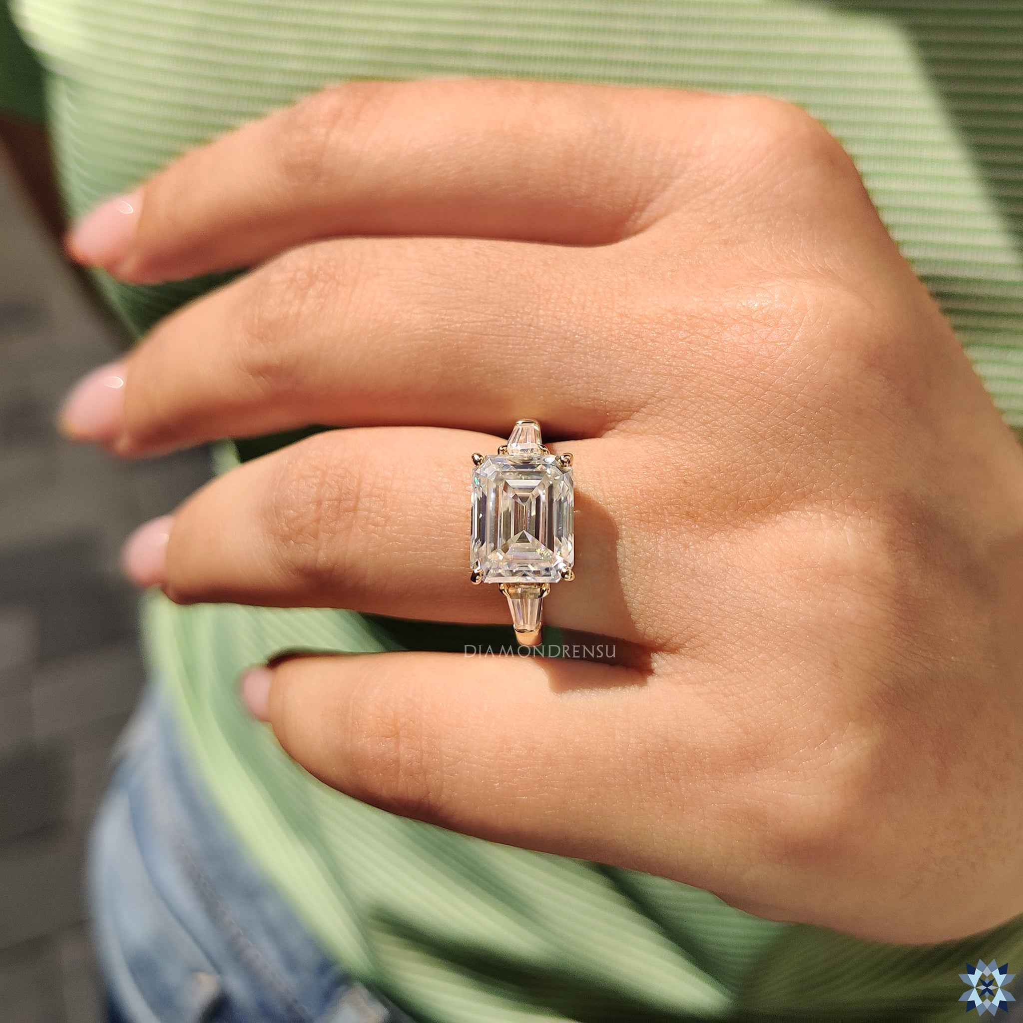 Elegant East-West ring with handmade yellow gold and moissanite brilliance.
