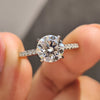 Round cut moissanite engagement ring set in classic cathedral setting.
