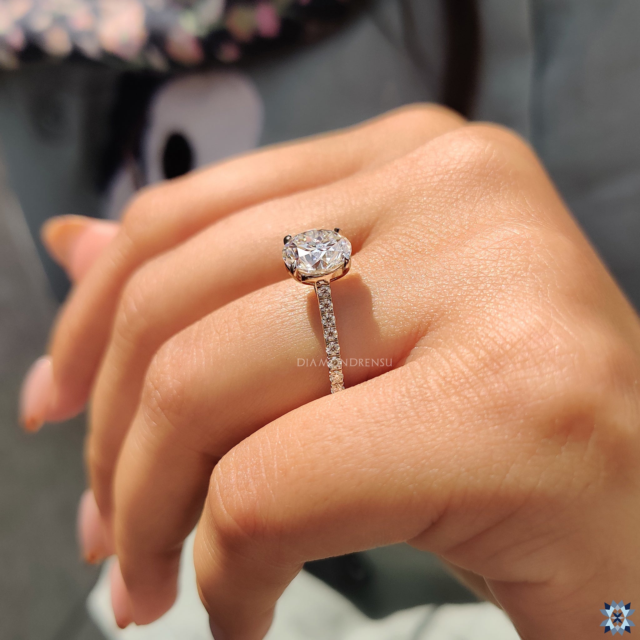 Cathedral setting ring with round moissanite and white gold finish.
