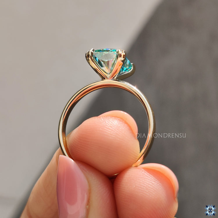 Radiant cut engagement ring in yellow gold with solitaire style.
