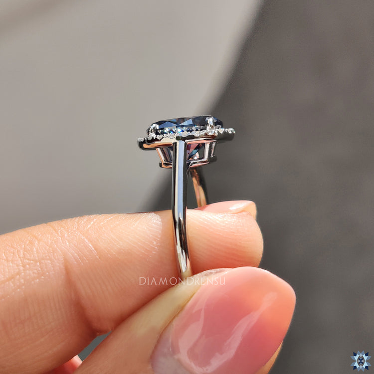 Buy engagement ring with deep blue oval moissanite and handmade halo craftsmanship.
