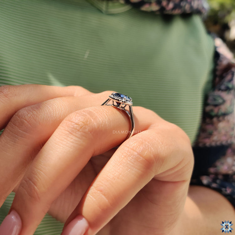 Moissanite for an engagement ring featuring oval cut center and round cut halo accent.
