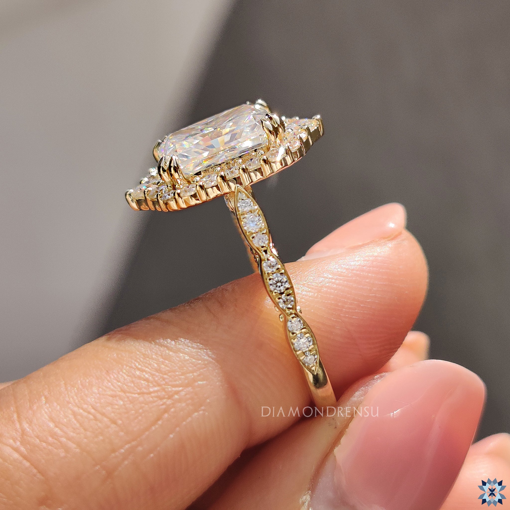 Radiant halo engagement ring with Art Deco styling and round pave diamonds.
