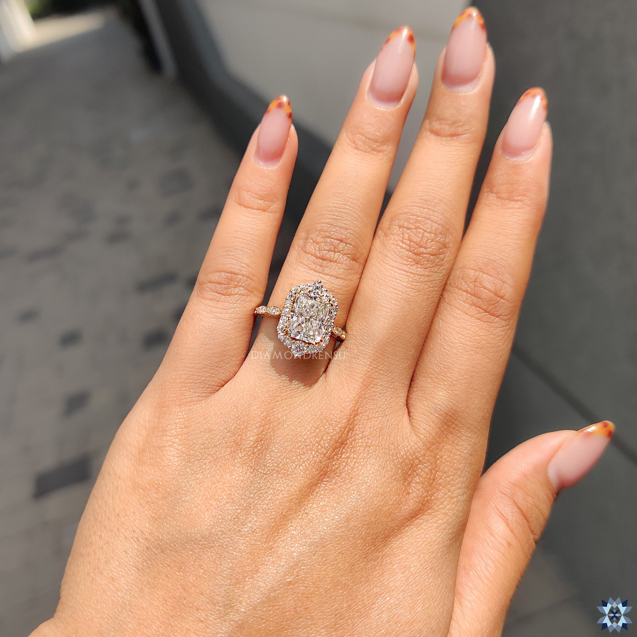 Round cut halo setting with pave band in a radiant moissanite engagement ring.
