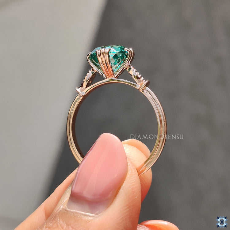 Handmade rose gold ring with dark green moissanite center.
