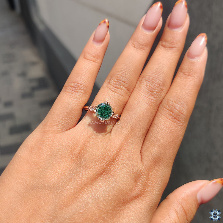 Seven stone engagement ring with round moissanite accents.
