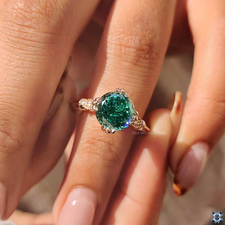 Vintage style rose gold engagement ring with moissanite stones.
