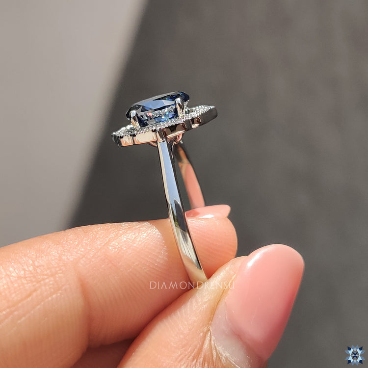 UK engagement ring with royal dark blue Moissanite and vintage-inspired halo setting.
