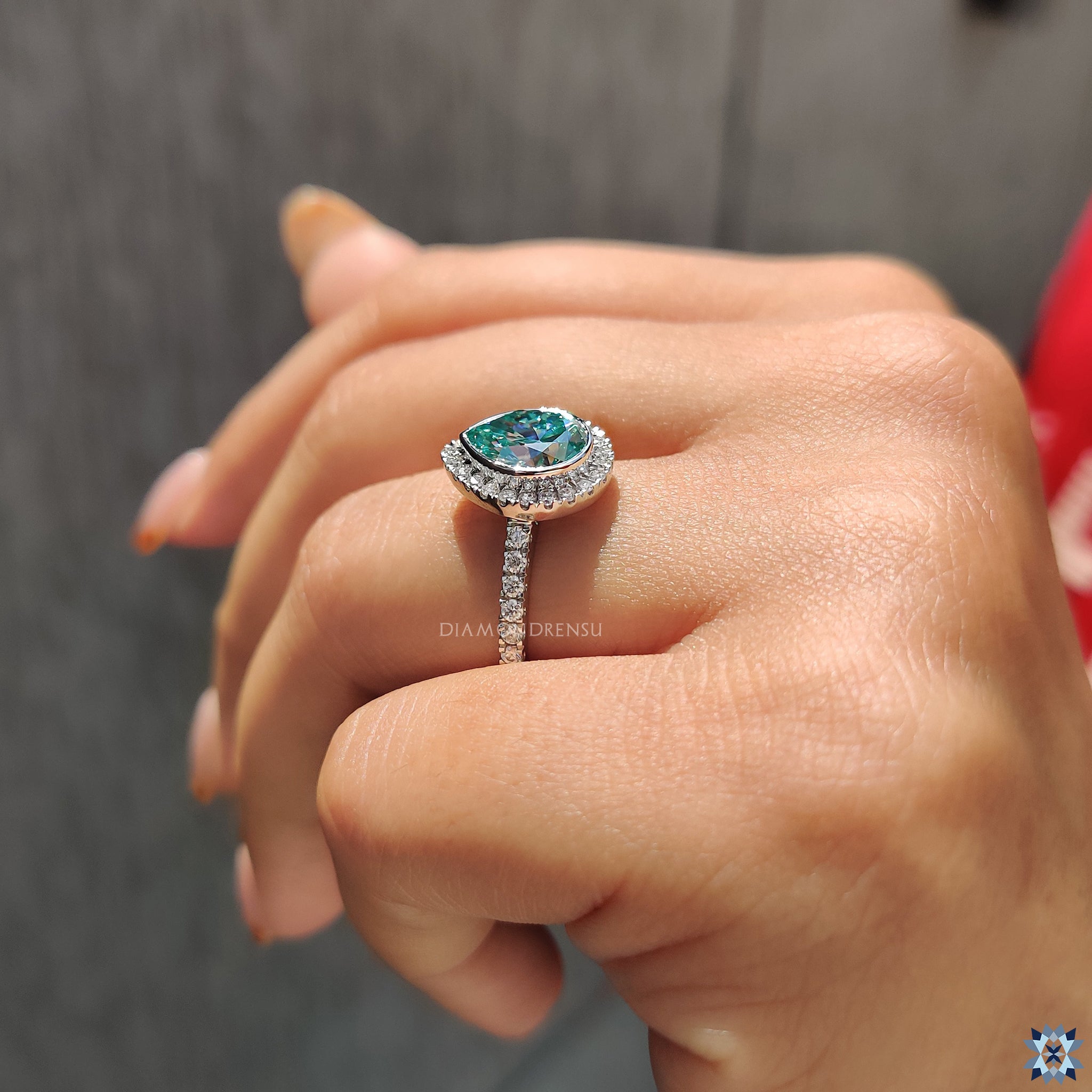 Bezel set moissanite engagement ring with round pave band in white gold.
