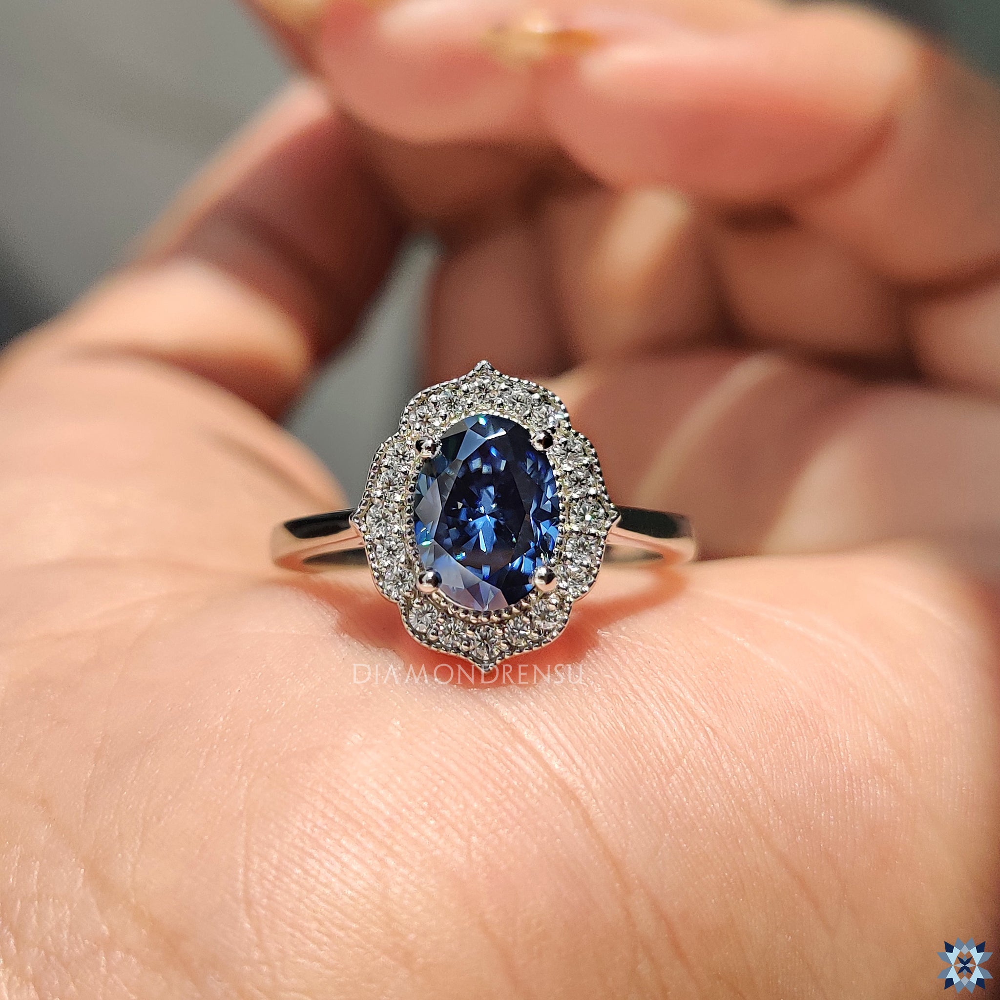 Diamondrensu UK engagement ring with royal dark blue Moissanite and antique-inspired halo.
