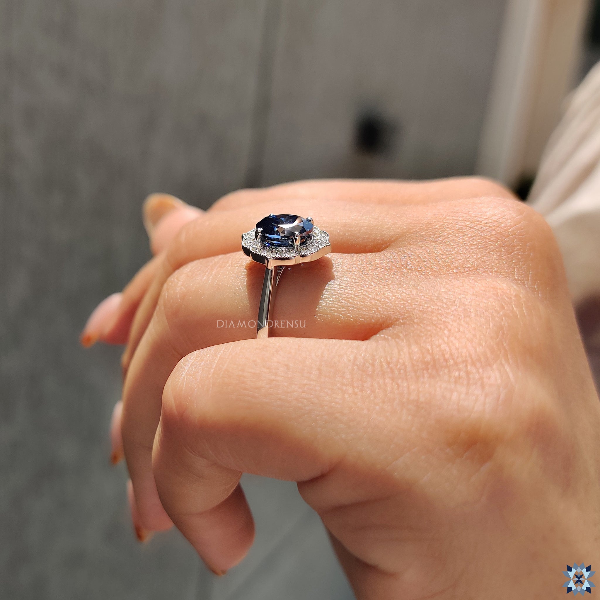 Handmade jewelry featuring oval cut Moissanite in halo setting with white gold band.
