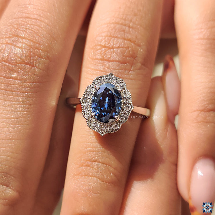 Moissanite for an engagement ring in royal blue shade with vintage white gold design.
