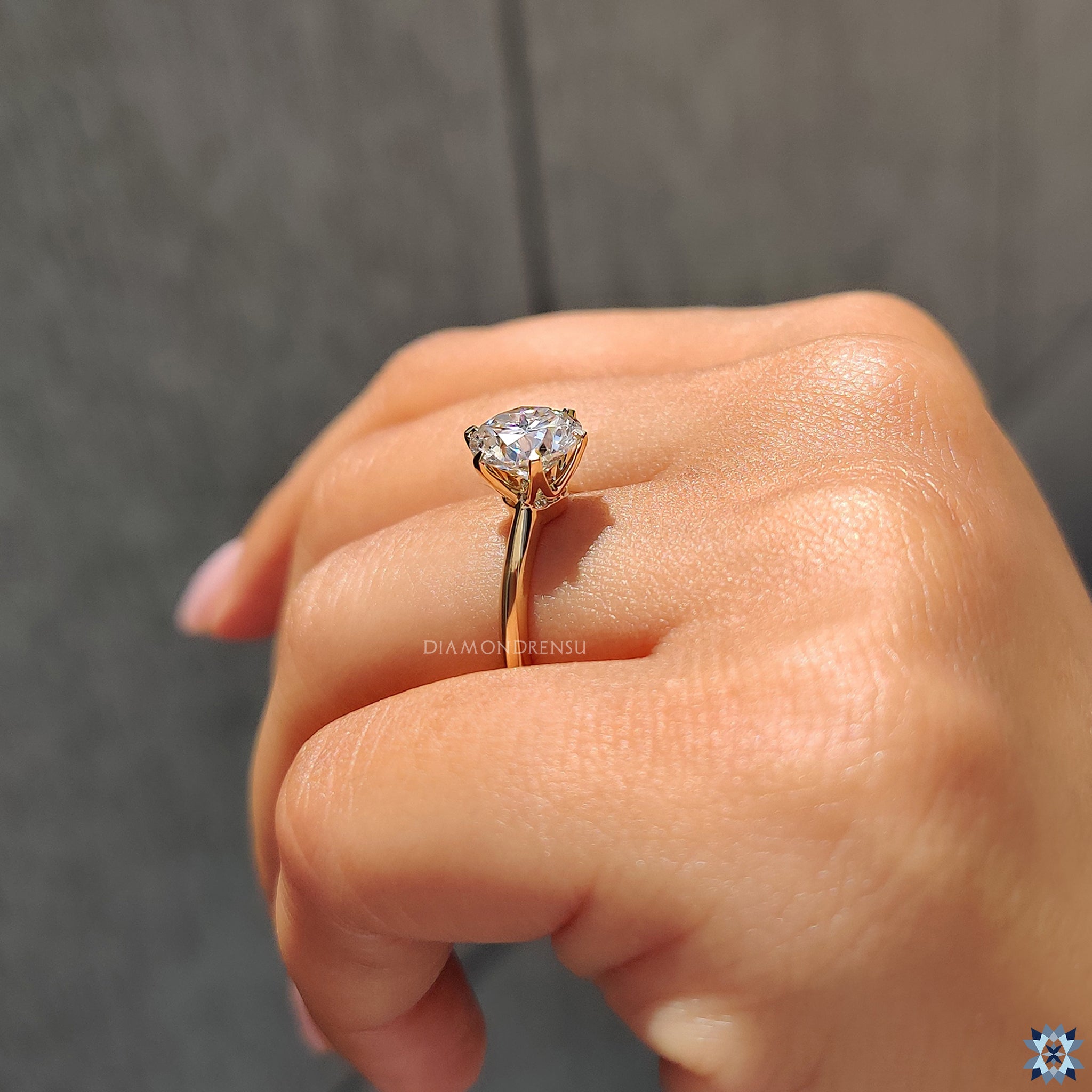 Knife edge band and solitaire round moissanite in Diamondrensu engagement style.
