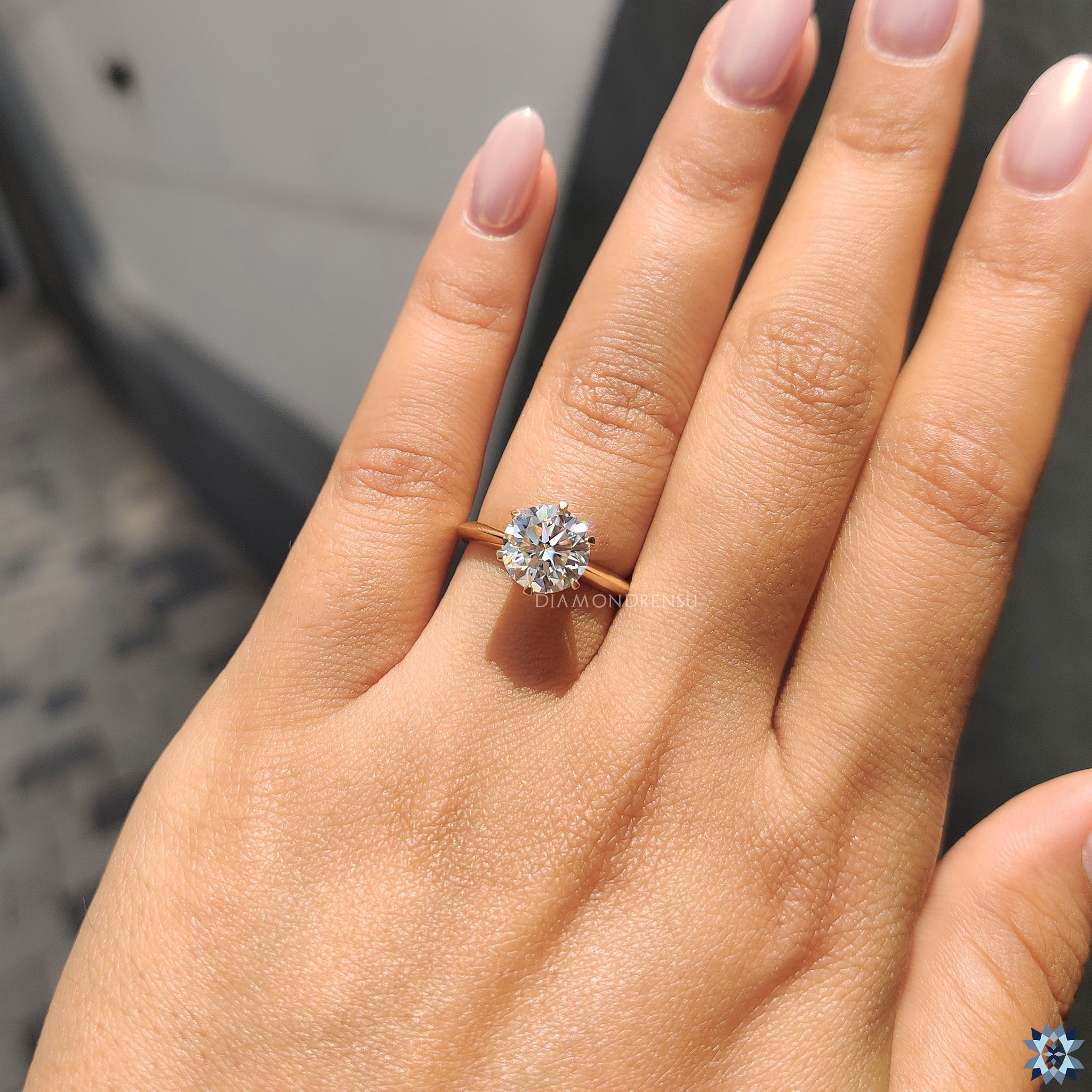 Handmade jewelry with solitaire moissanite and knife edge shank band in gold.
