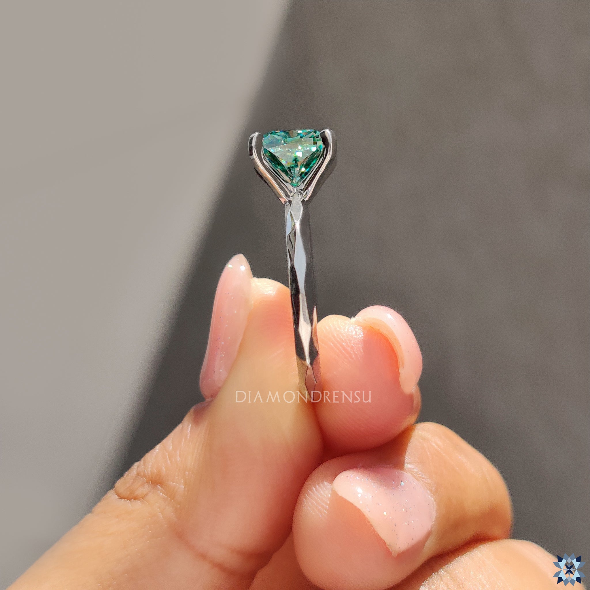 Cyan blue moissanite engagement ring with handcrafted solitaire finish.
