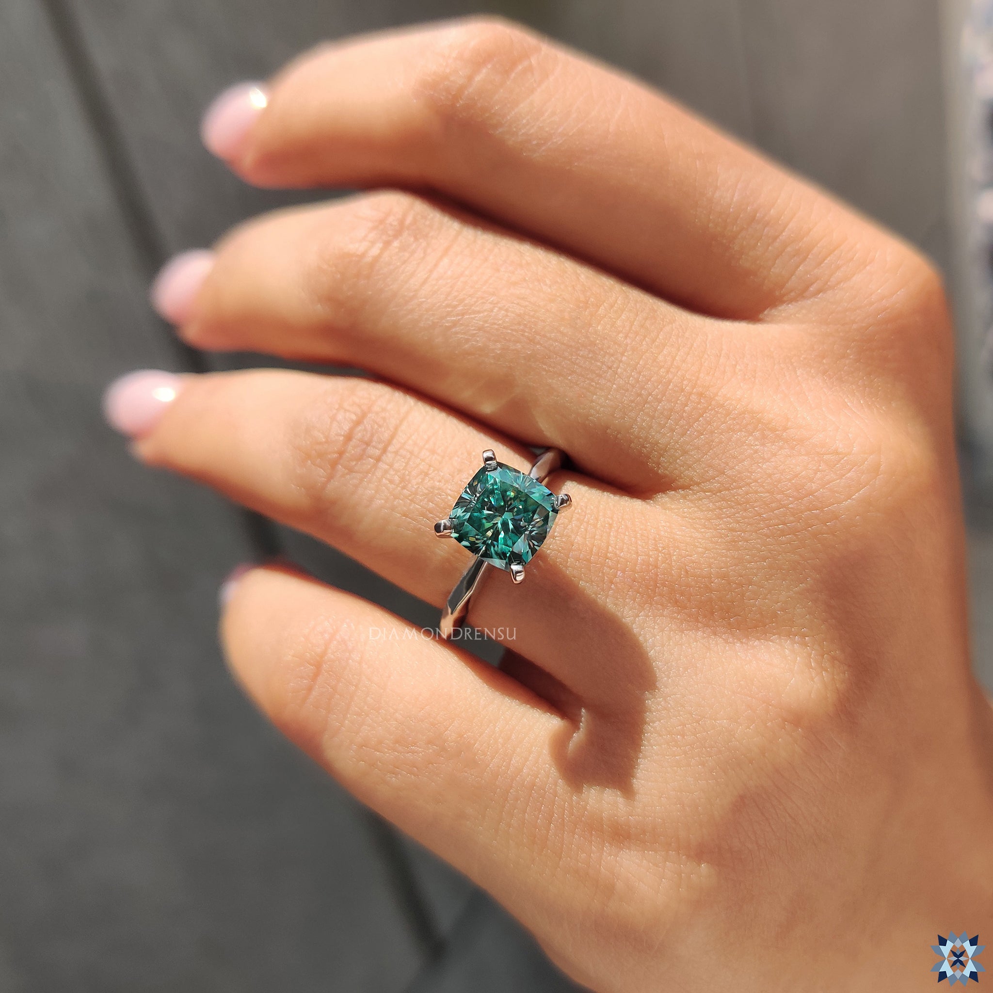 Diamondrensu UK engagement ring featuring a cushion cut moissanite stone.
