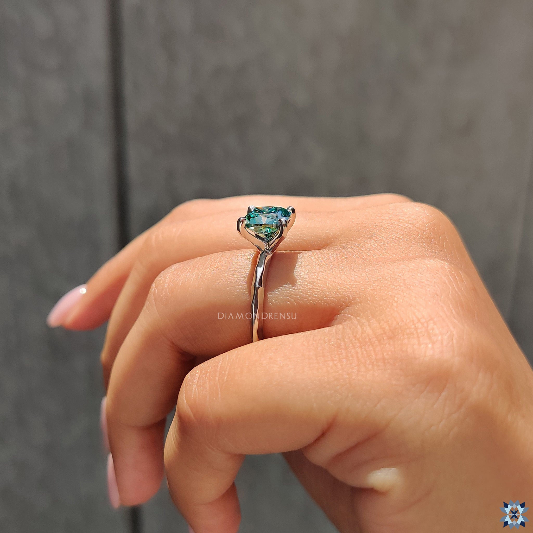 Buy engagement ring with four tab prong setting and vibrant cyan blue moissanite.

