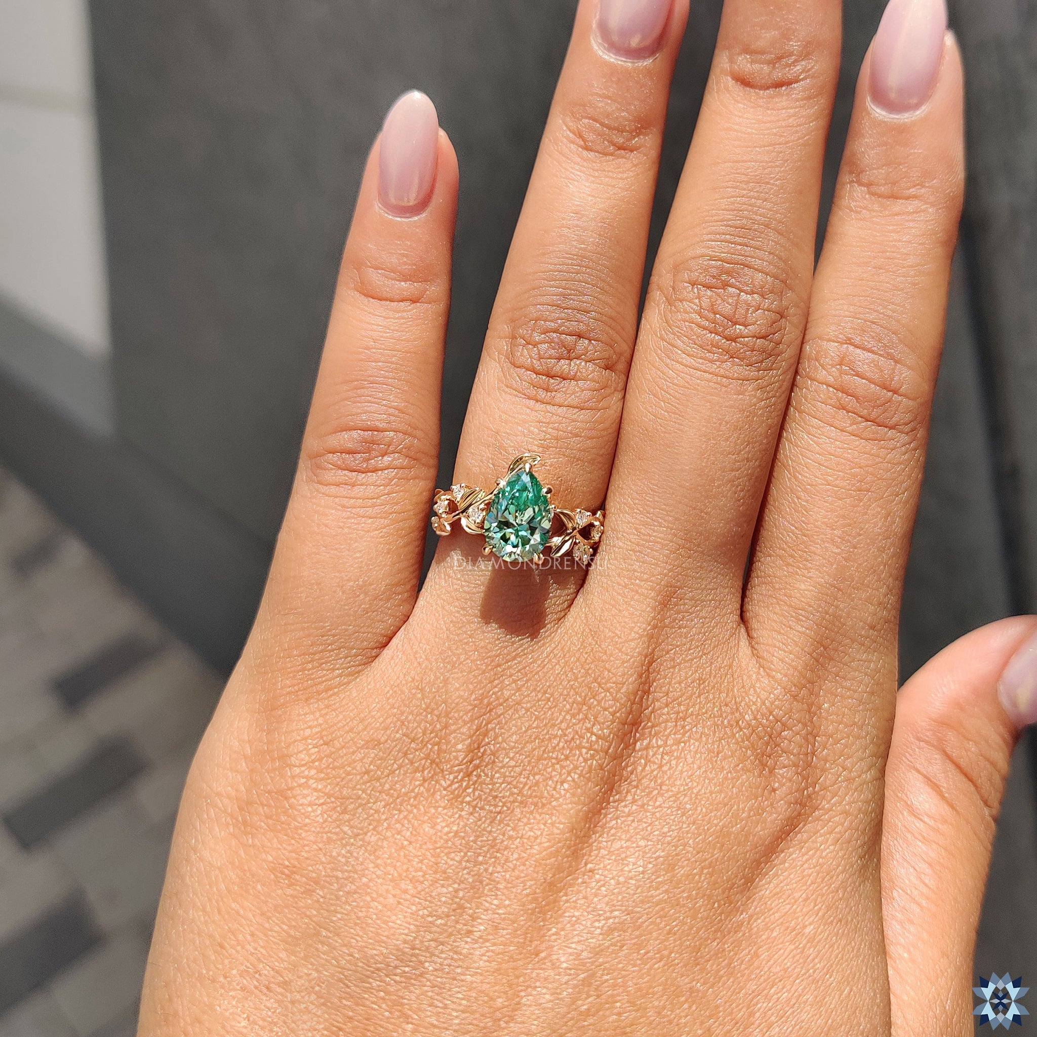 Handmade yellow gold engagement ring with 5 claw prong and round cut side stones.
