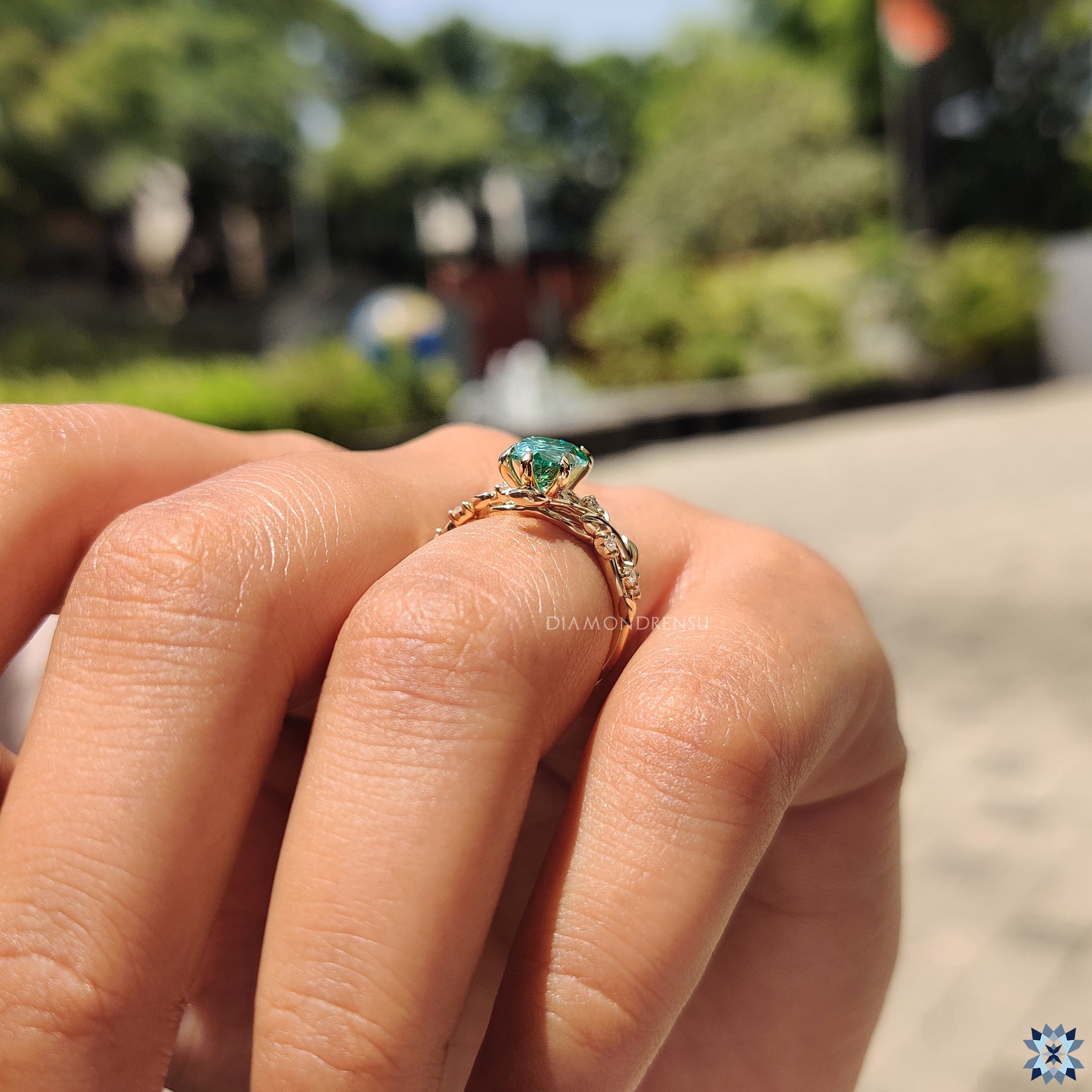Artisan engagement ring with green moissanite in a unique nature inspired style.
