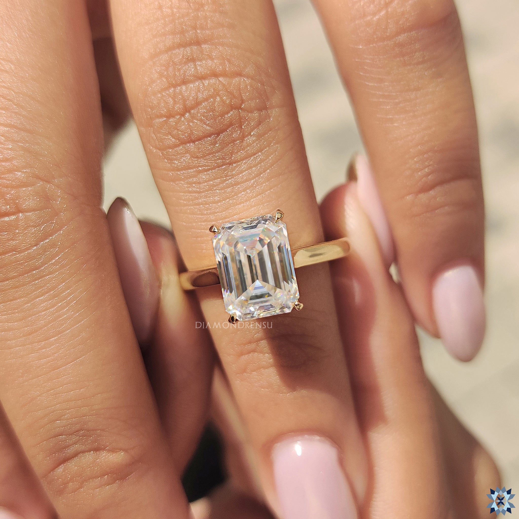 Diamondrensu UK engagement ring in a simple solitaire style with emerald cut moissanite.
