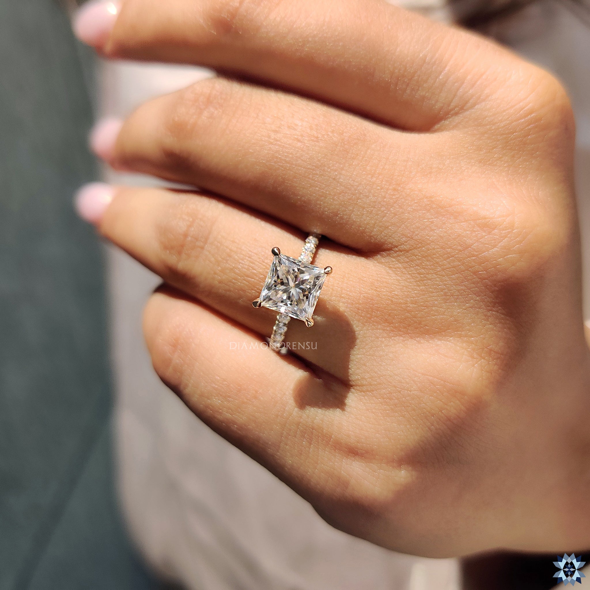 UK engagement ring in gold with round pave band and princess Moissanite center.
