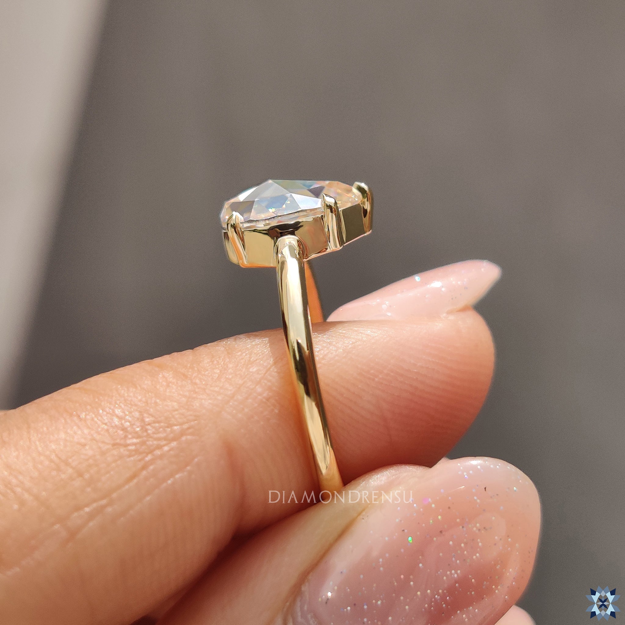 UK engagement ring with pear rose cut Moissanite and handcrafted gold band.
