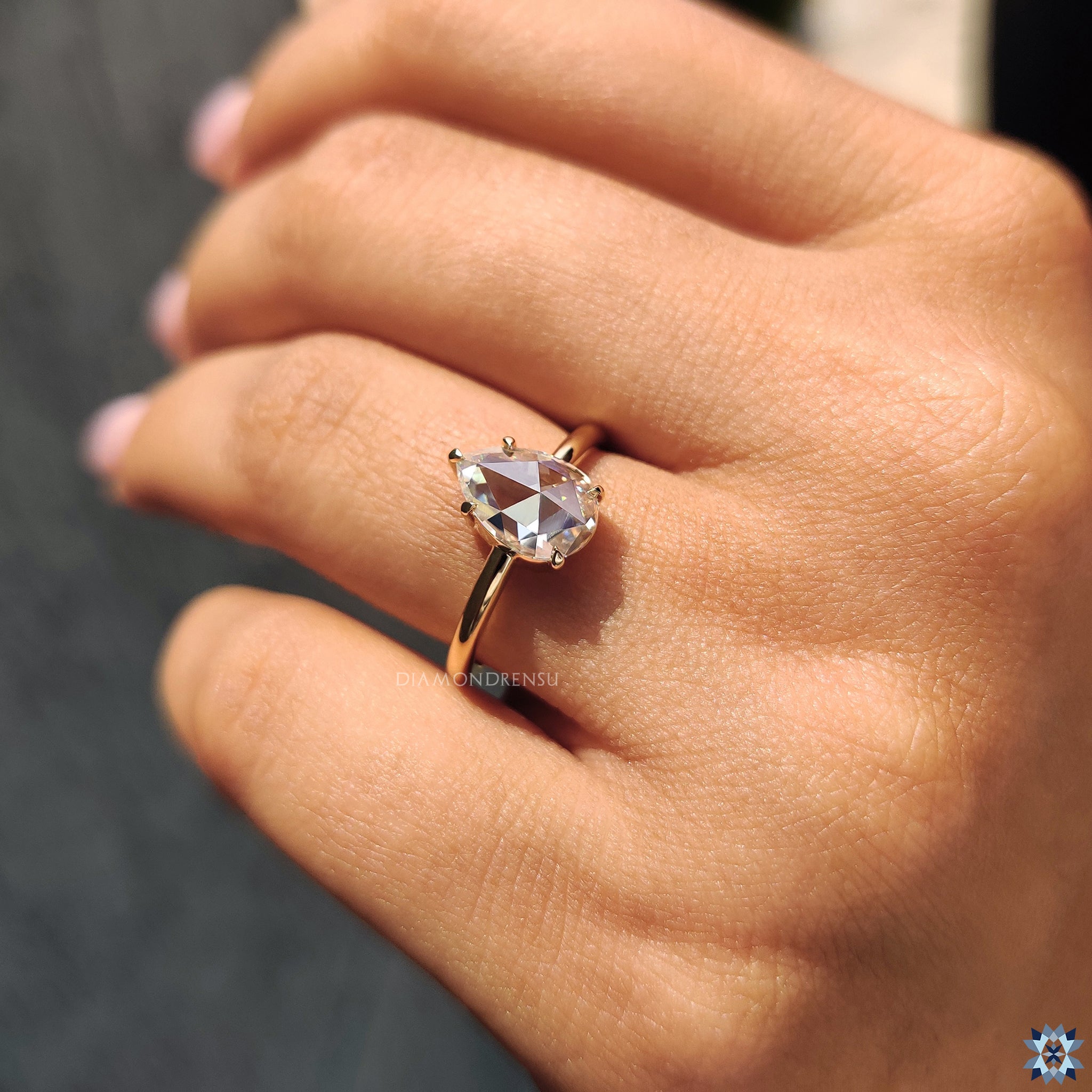 Yellow gold handmade jewelry featuring pear rose cut Moissanite ring.

