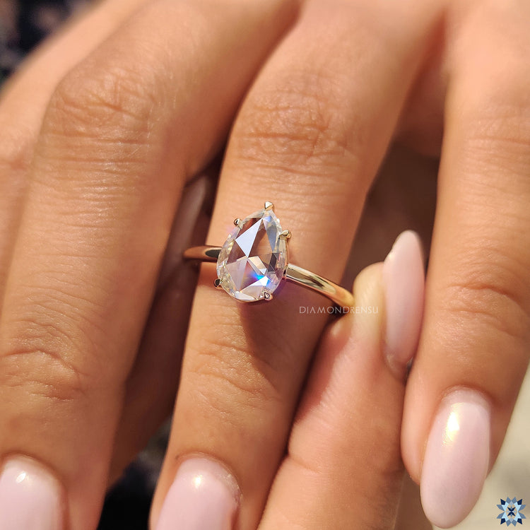 Moissanite for an engagement ring with rose cut pear shape and 5 prong secure hold.
