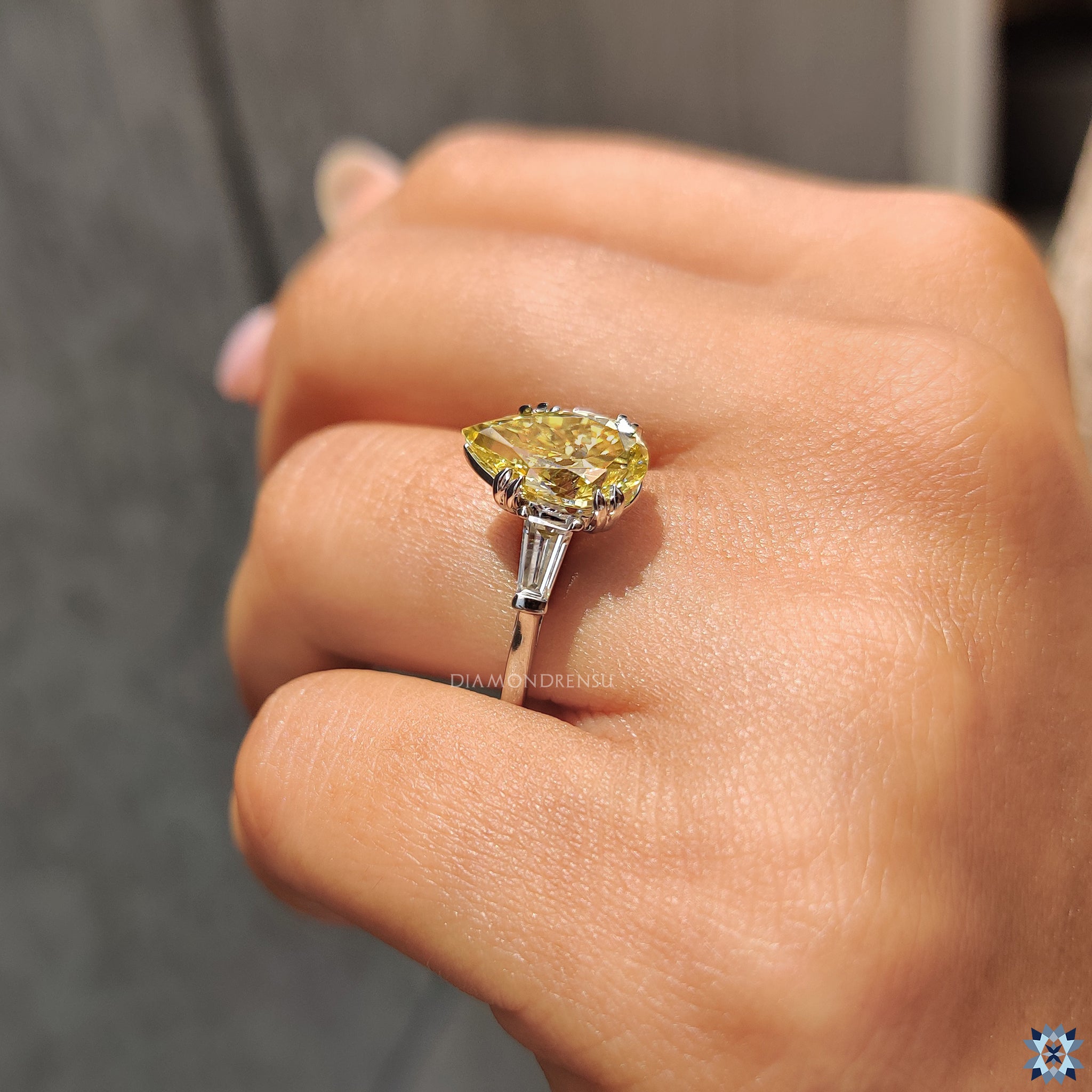 Canary yellow engagement ring with tapered baguette side stones in polished white gold.
