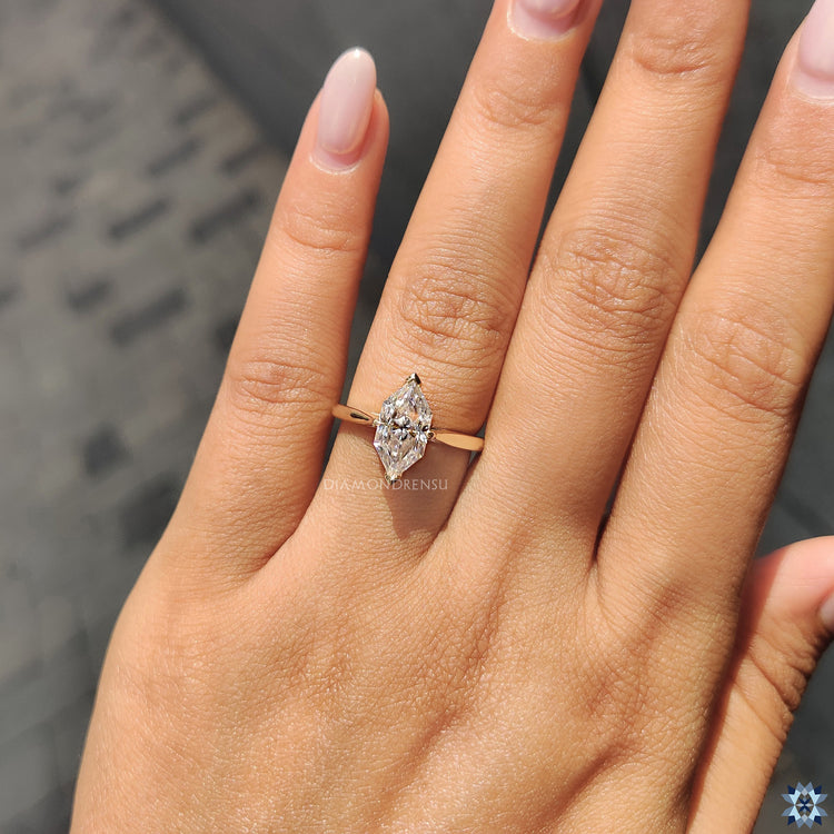 Yellow gold engagement ring with tapered shank and Dutch marquise moissanite.
