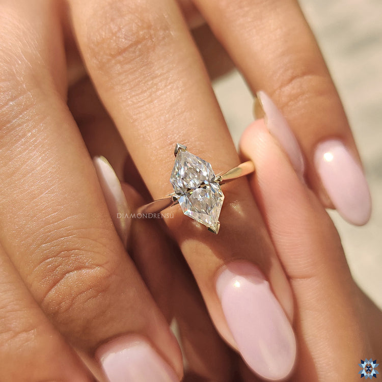 Dutch marquise moissanite solitaire ring in a cathedral setting.
