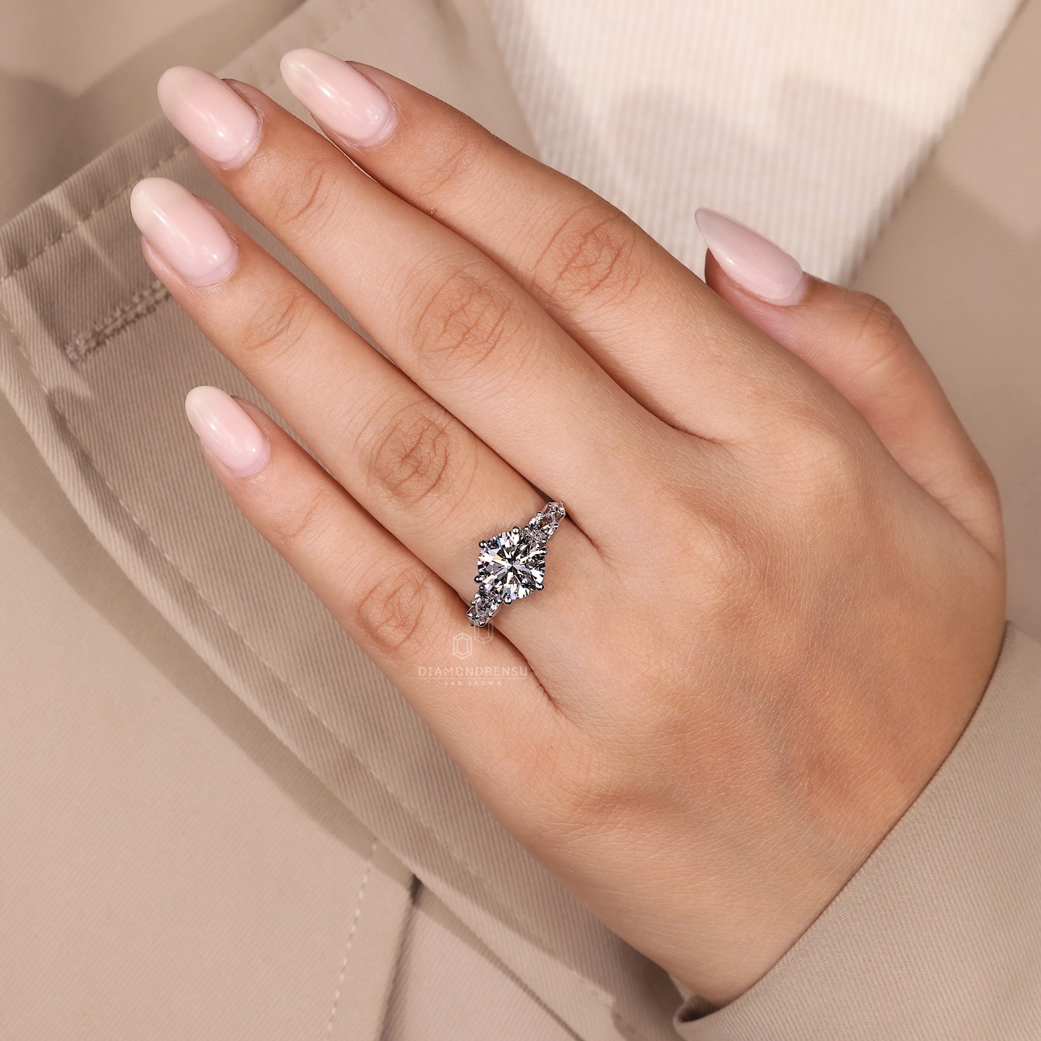 Designer engagement ring with round and pear stones.
