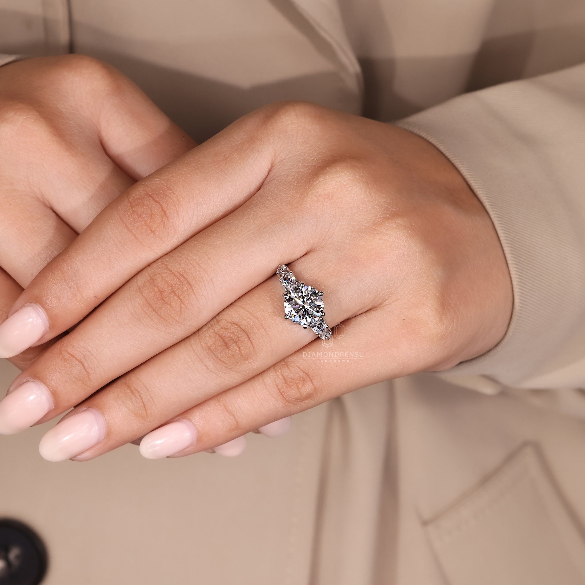 Custom engagement ring with round and pear design.
