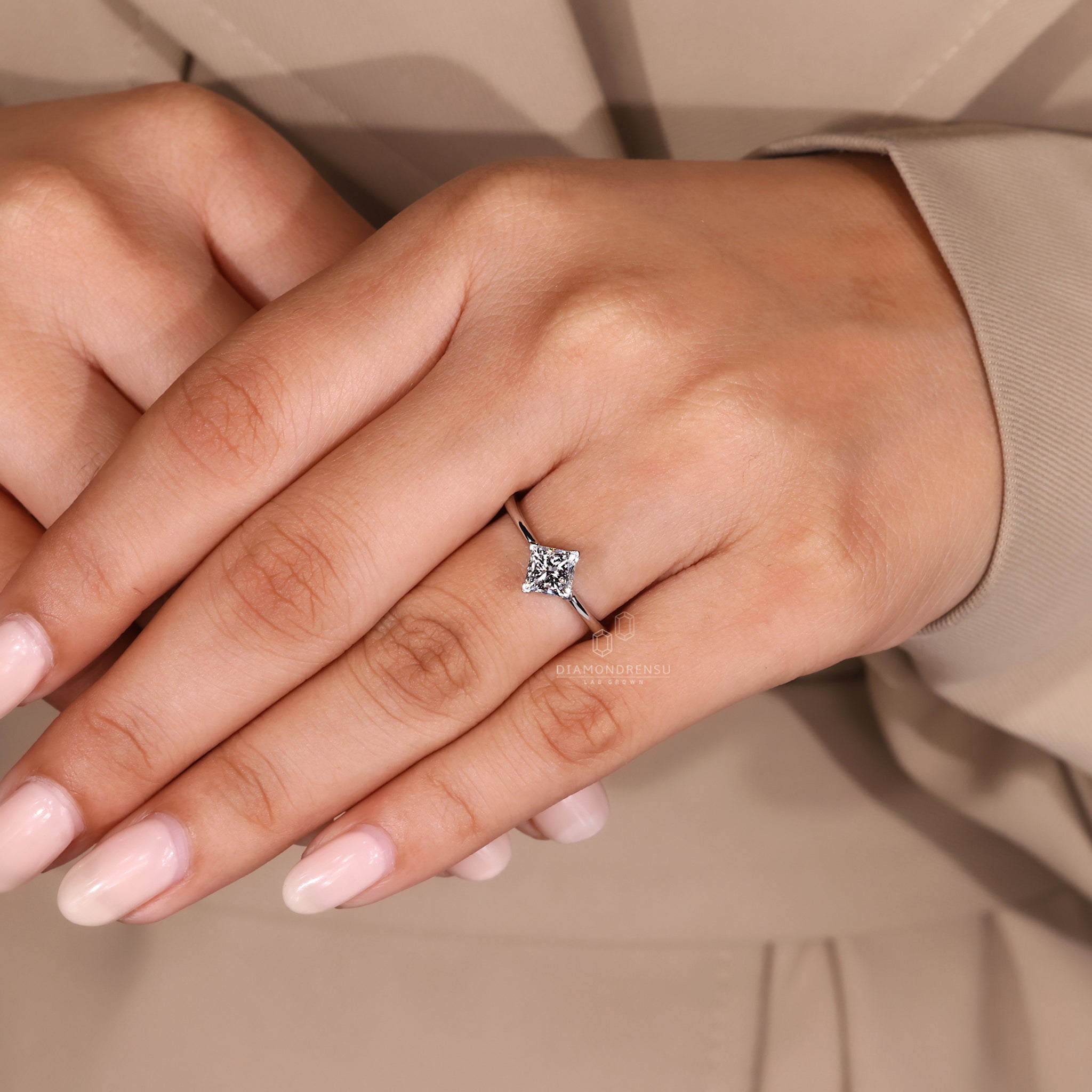 Engagement ring with compass prong and princess cut diamond.
