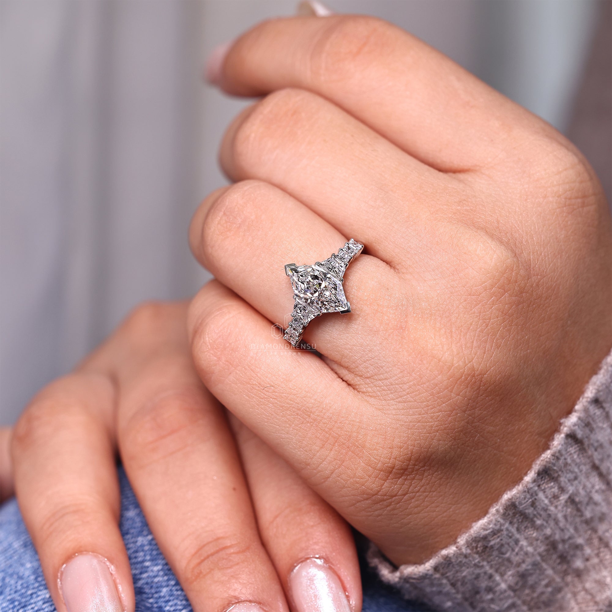 Princess side stone ring crafted in white gold.
