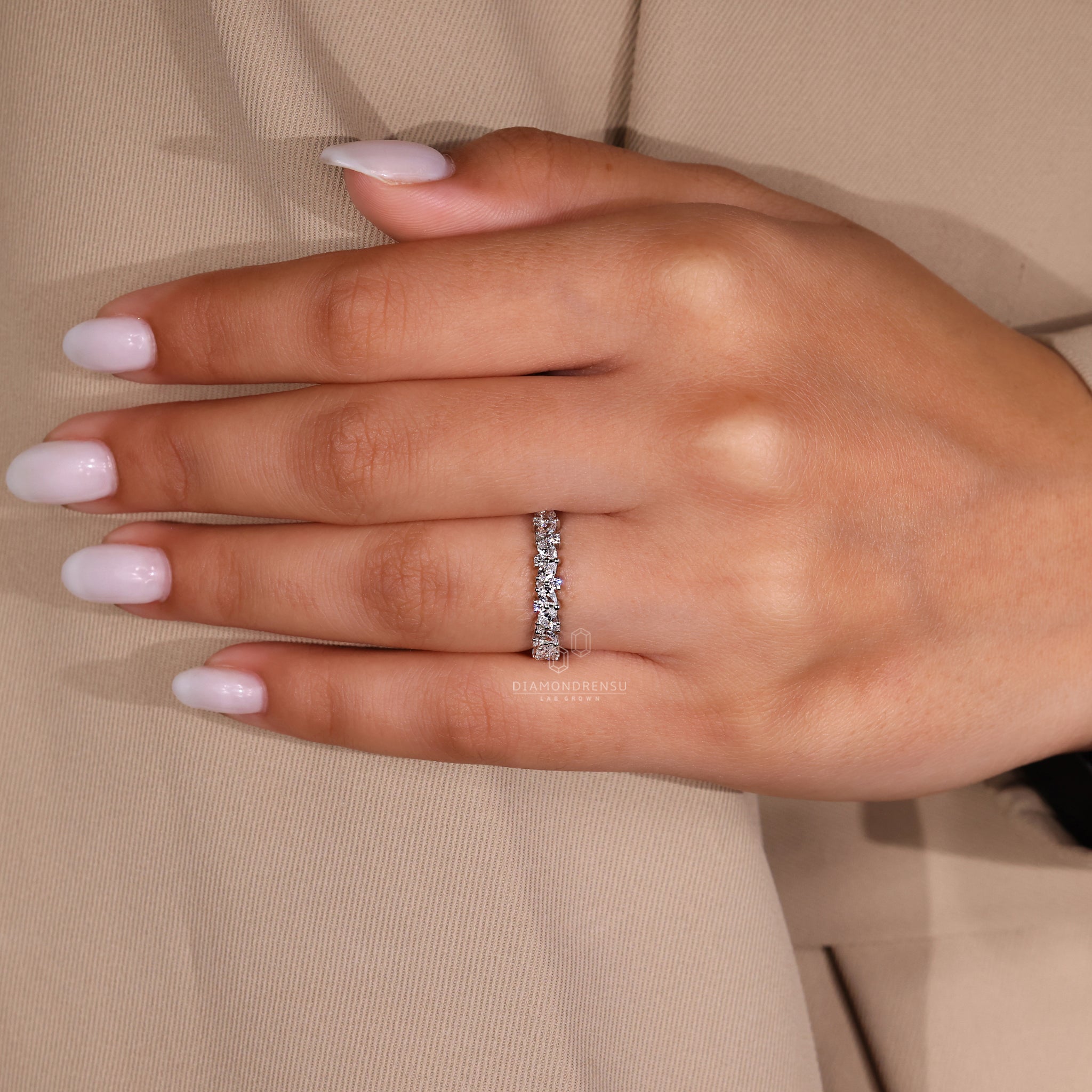 Lab diamond band with teardrop and round stones.
