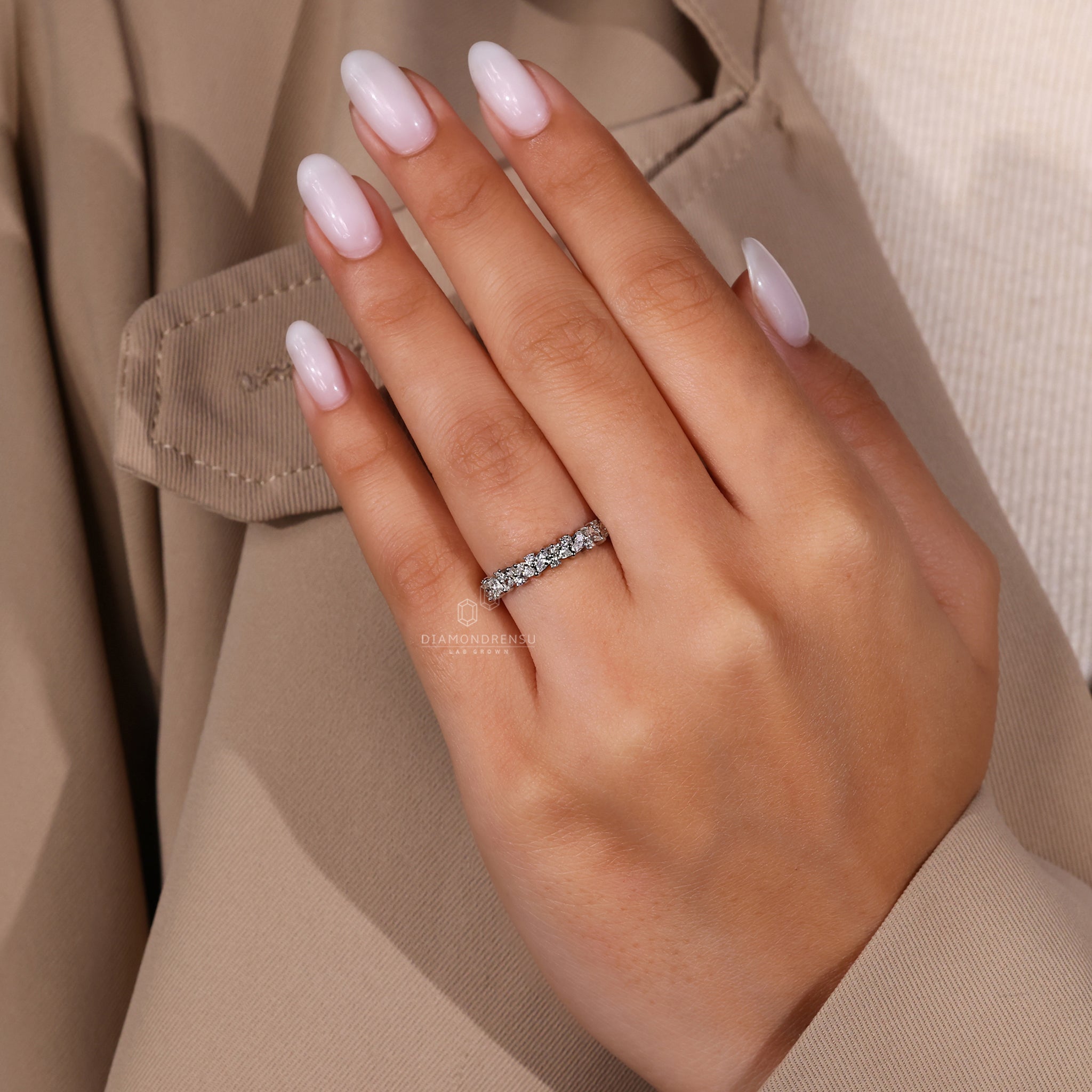 White gold wedding band with pear and round mix.
