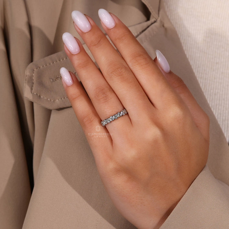 White gold wedding band with pear and round mix.
