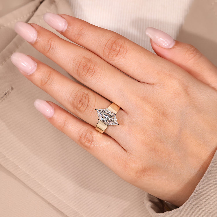 Solitaire marquise diamond ring with tapered shank band
