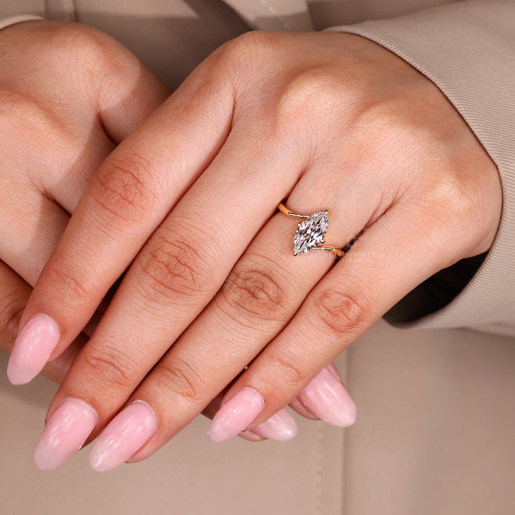 Solitaire engagement ring with compass prong setting and handmade finish.