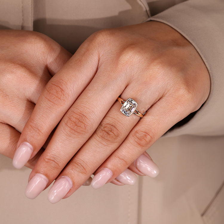 Bezel engagement ring with split shank band and solitaire style.