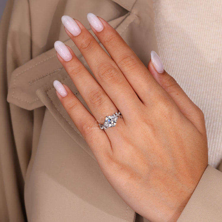 Diamondrensu ring with Old European cut centre diamond and nature inspired design.
