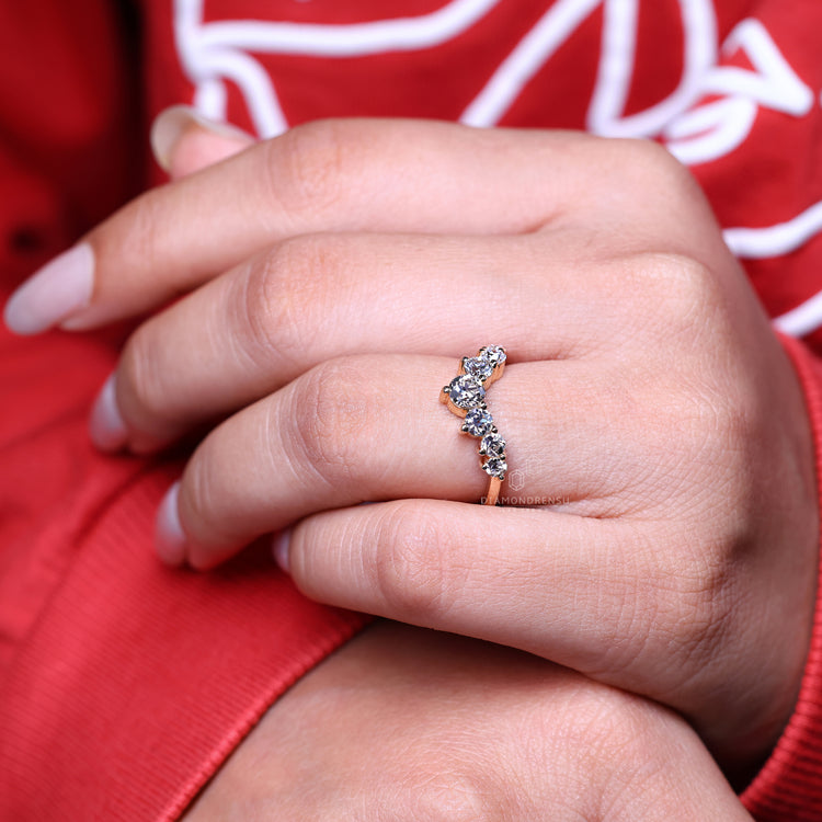 Curved diamond band with a shared prong setting.
