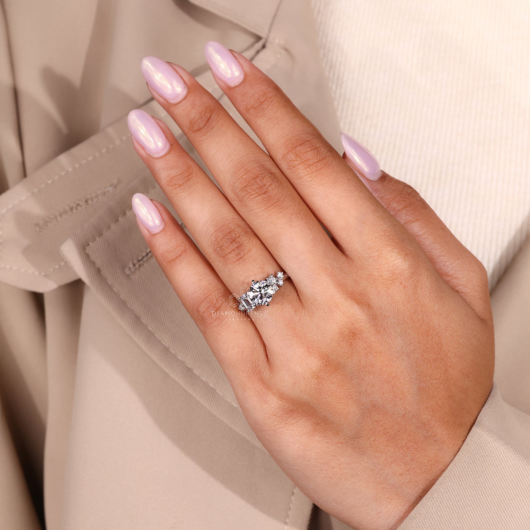 Buy engagement ring with emerald and round stones.
