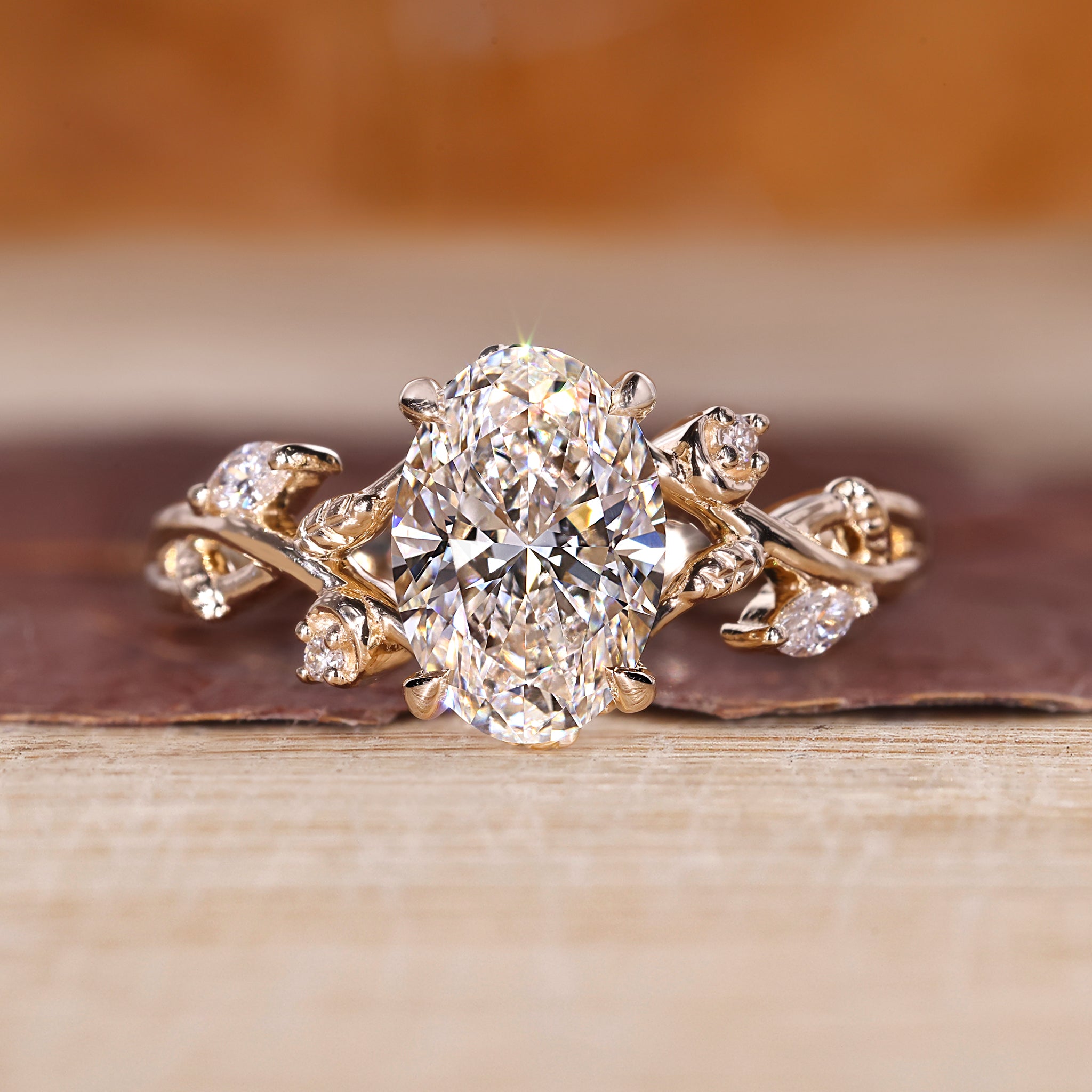 Gold oval diamond engagement ring with marquise and round stones