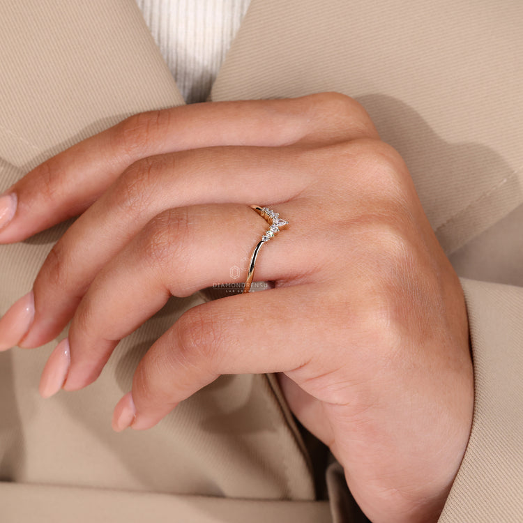 Prong setting band with pear and round cut diamonds.